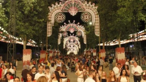 Ornamental light arch and a crowd strolling in a night fair